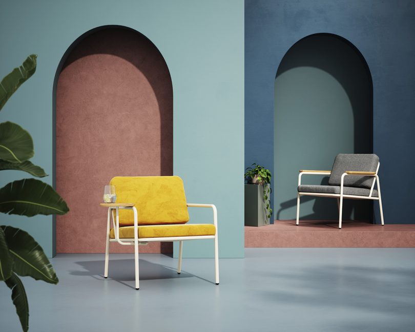 two indoor/outdoor armchairs styled in front of dusty blue walls with arches