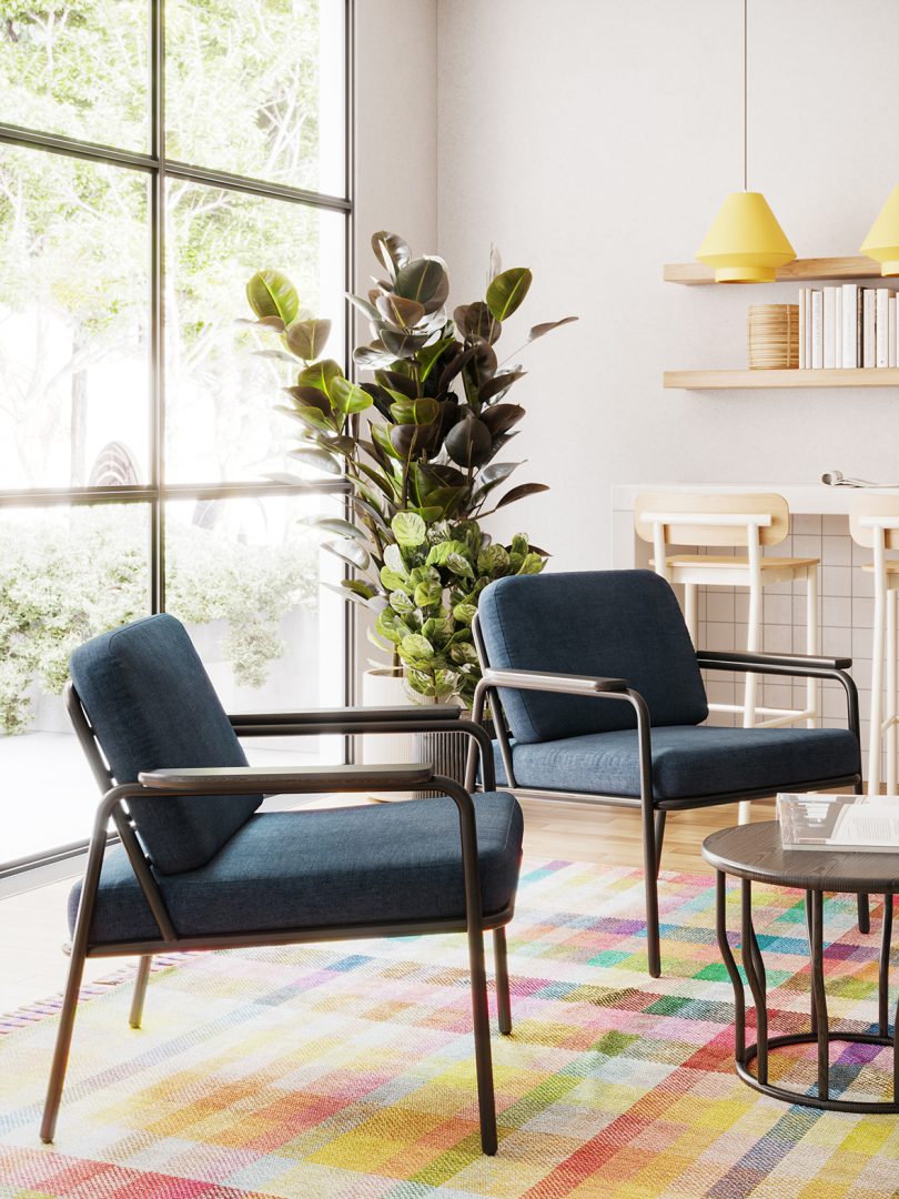 two indoor/outdoor armchairs around a coffee table in front of a kitchen island with stools