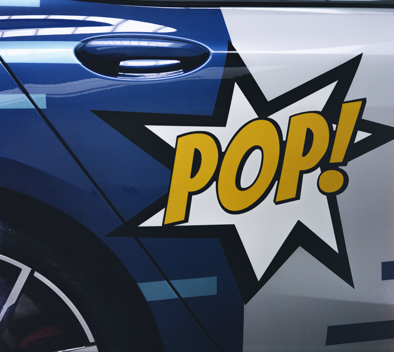 car door with the word POP! in yellow, blue, and silver