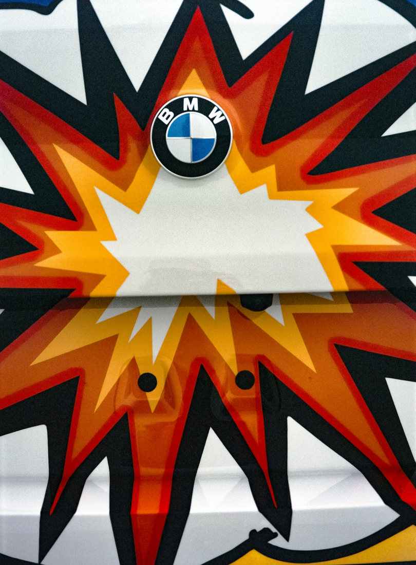 graphic explosion in yellow, orange, and red with BMW badge