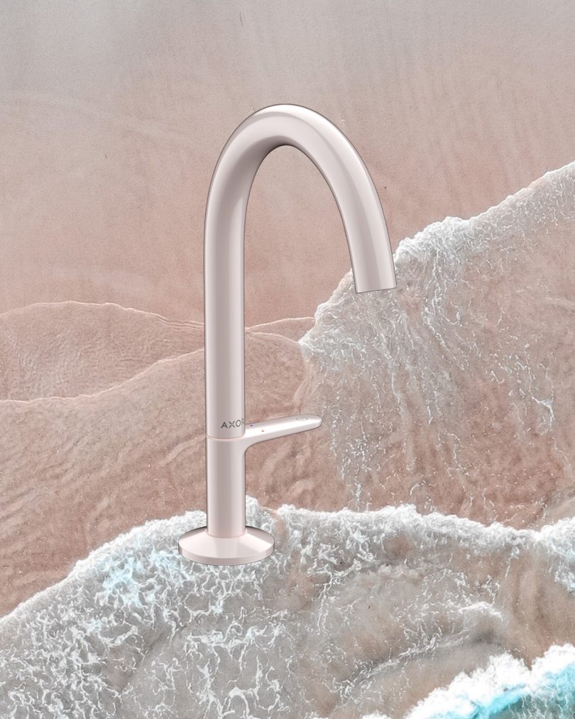 light pink sink faucet superimposed over image of the beach