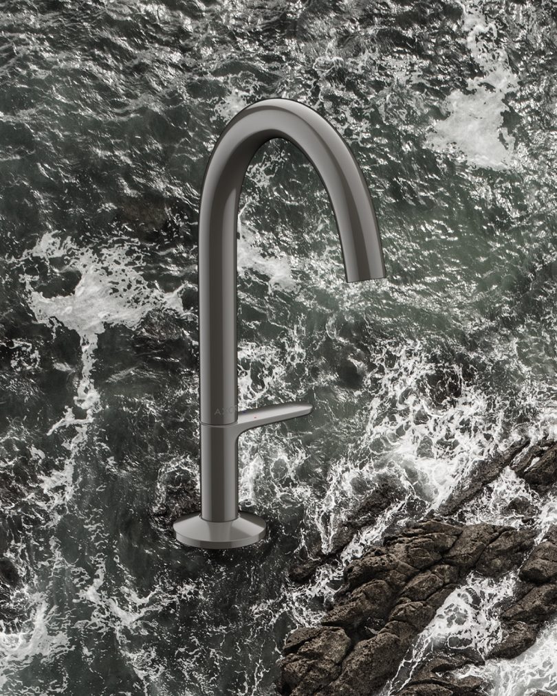 black sink faucet superimposed over image of a rocky beach
