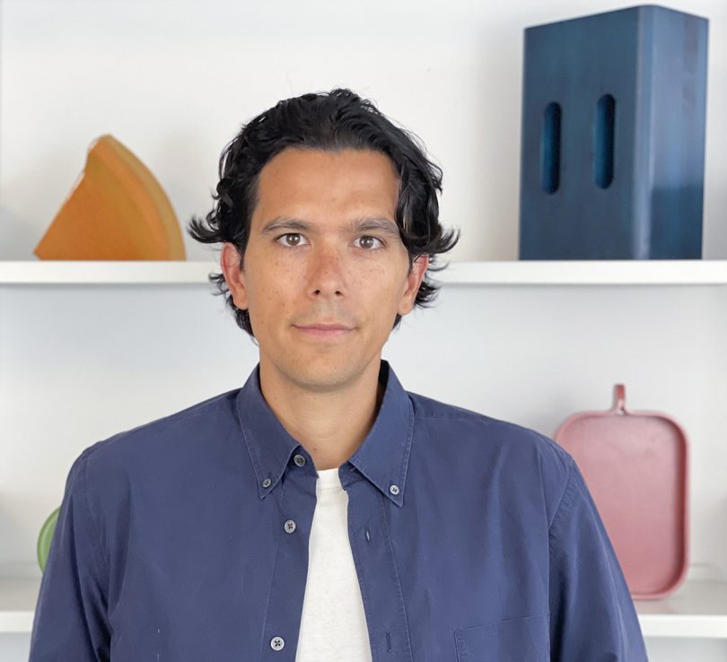 Portrait of Airsign founder and designer, Joseph Guerra, wearing a blue button up shirt with white tee peeking from underneath.