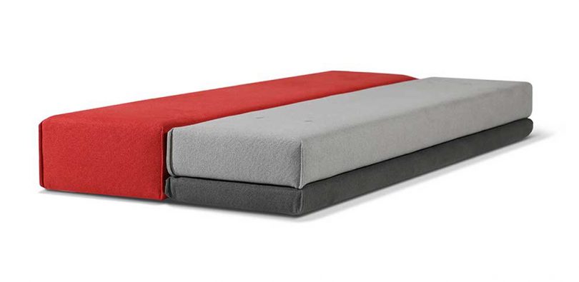 transformable grey and red settee opened up to bed form on white background