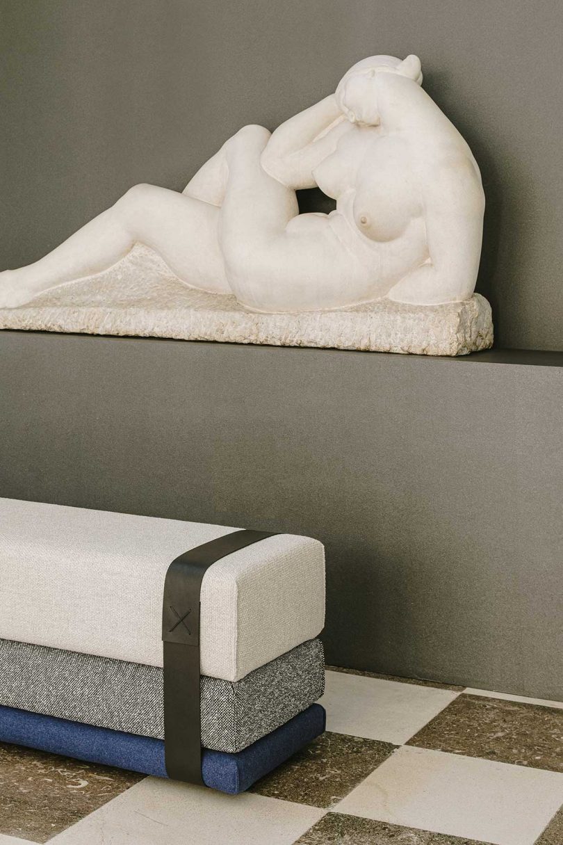 detail of upholstered next to marble statue