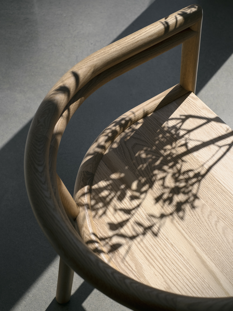 overhead view of curved wood armchair