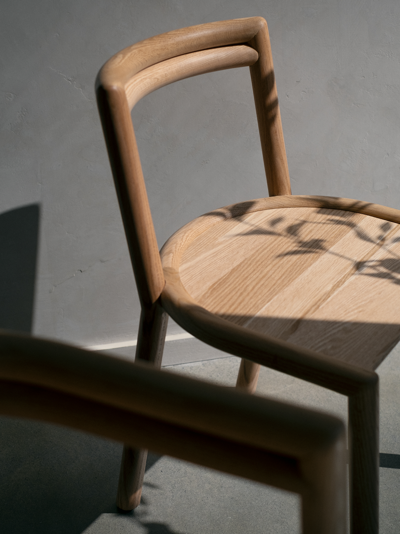 curved wood chair in shadows