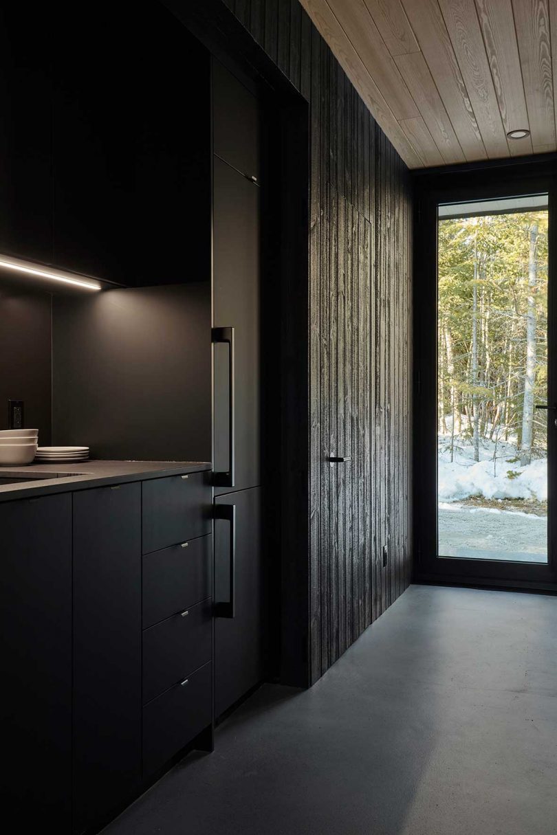 A Compact, Modern Cabin in the Woods That Reflects the Trees