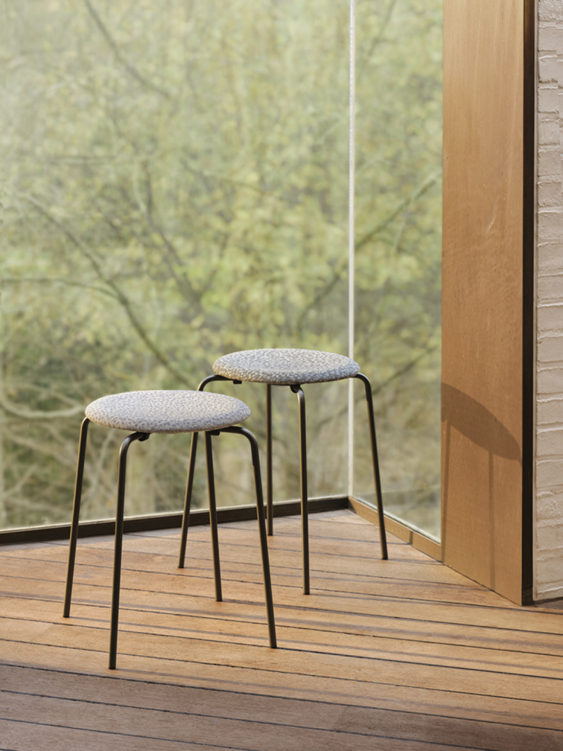 two short stools near a window