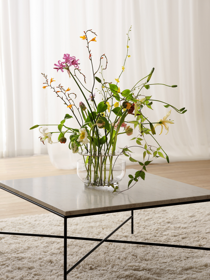 glass vase filled with wildflowers on coffee table