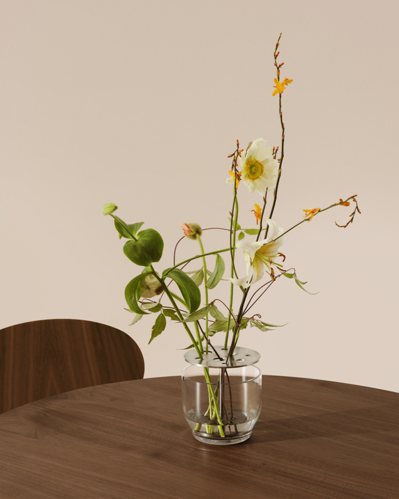 glass vase filled with wildflowers on dining table