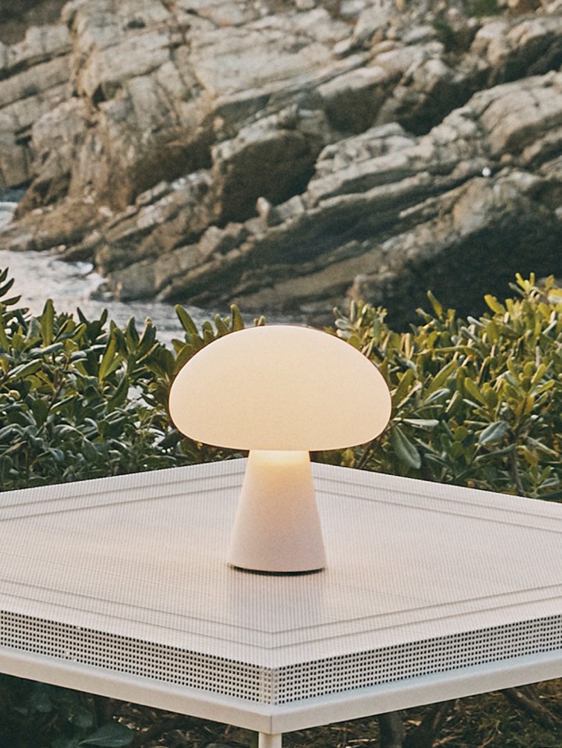 lit mushroom-shaped lamp sitting on small table
