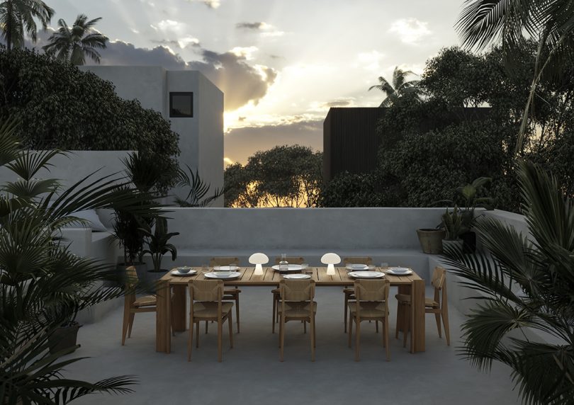 two lit mushroom-shaped lamps on an outdoor dining table with eight chairs
