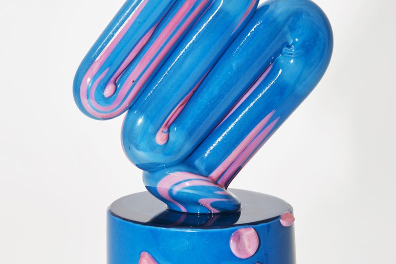 detail of blue and light pink art object on white background