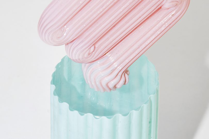 detail of light blue and light pink art object on white background