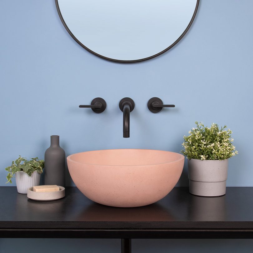pink bowl sink with black wall fixtures
