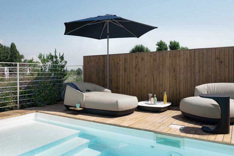 lounger, table, and umbrella poolside