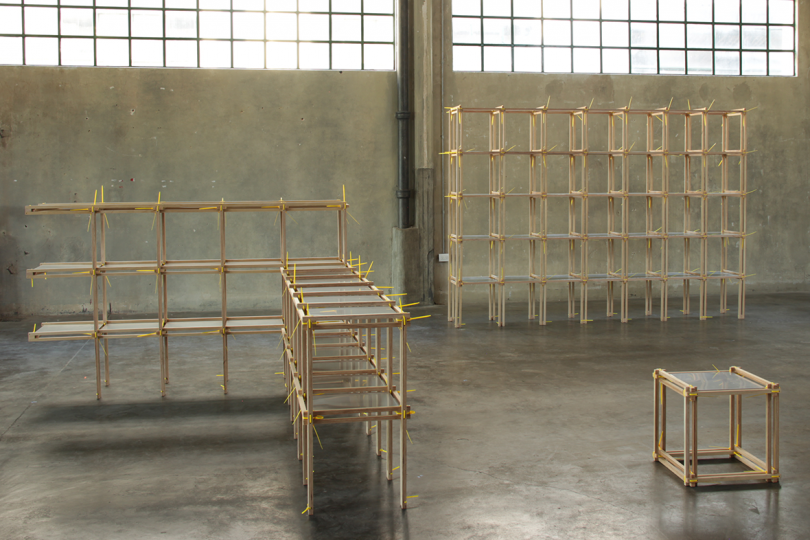 skeletal wood furniture system in an empty warehouse