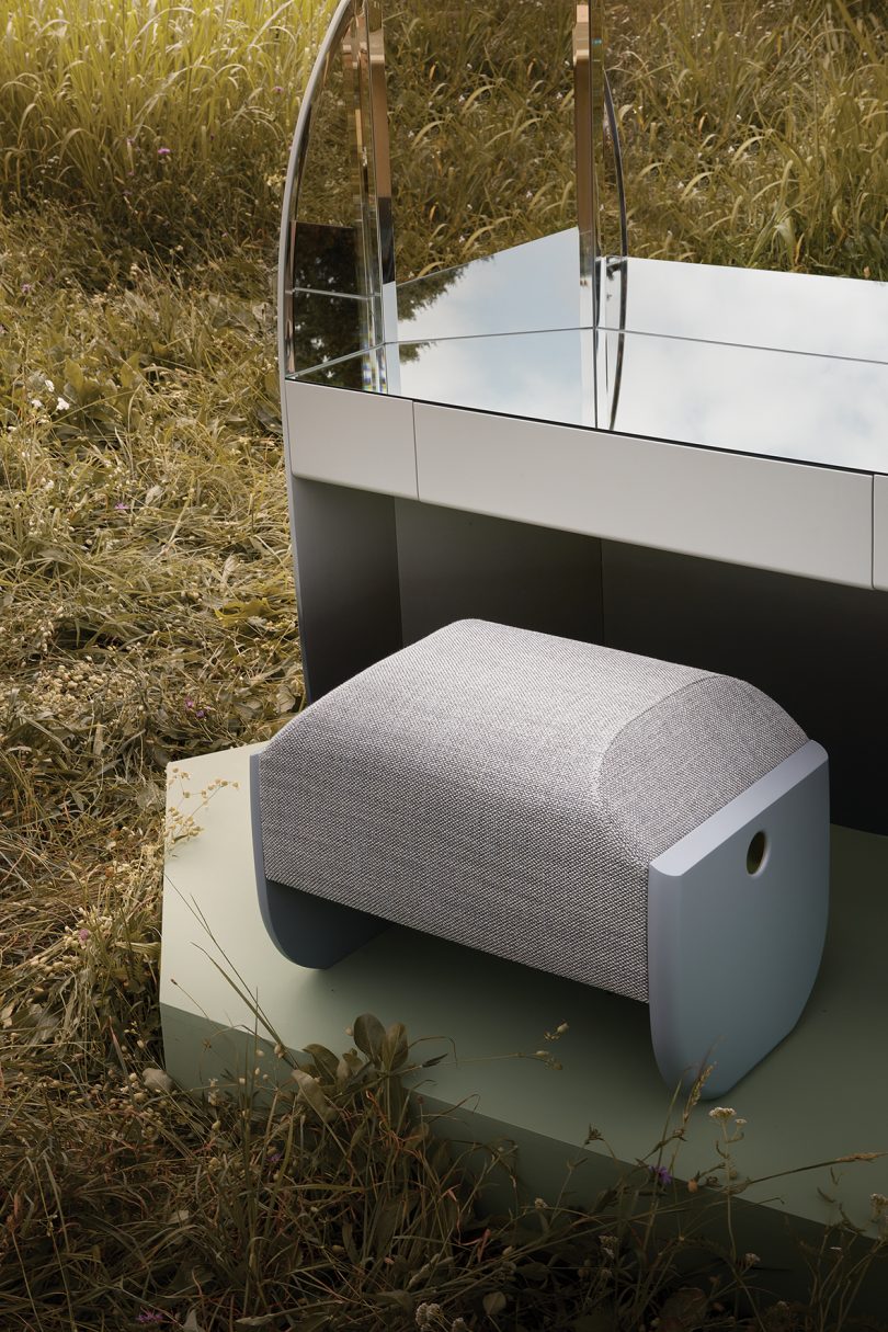 detail of vanity with trifold mirror, drawer, and bench in the middle of a field