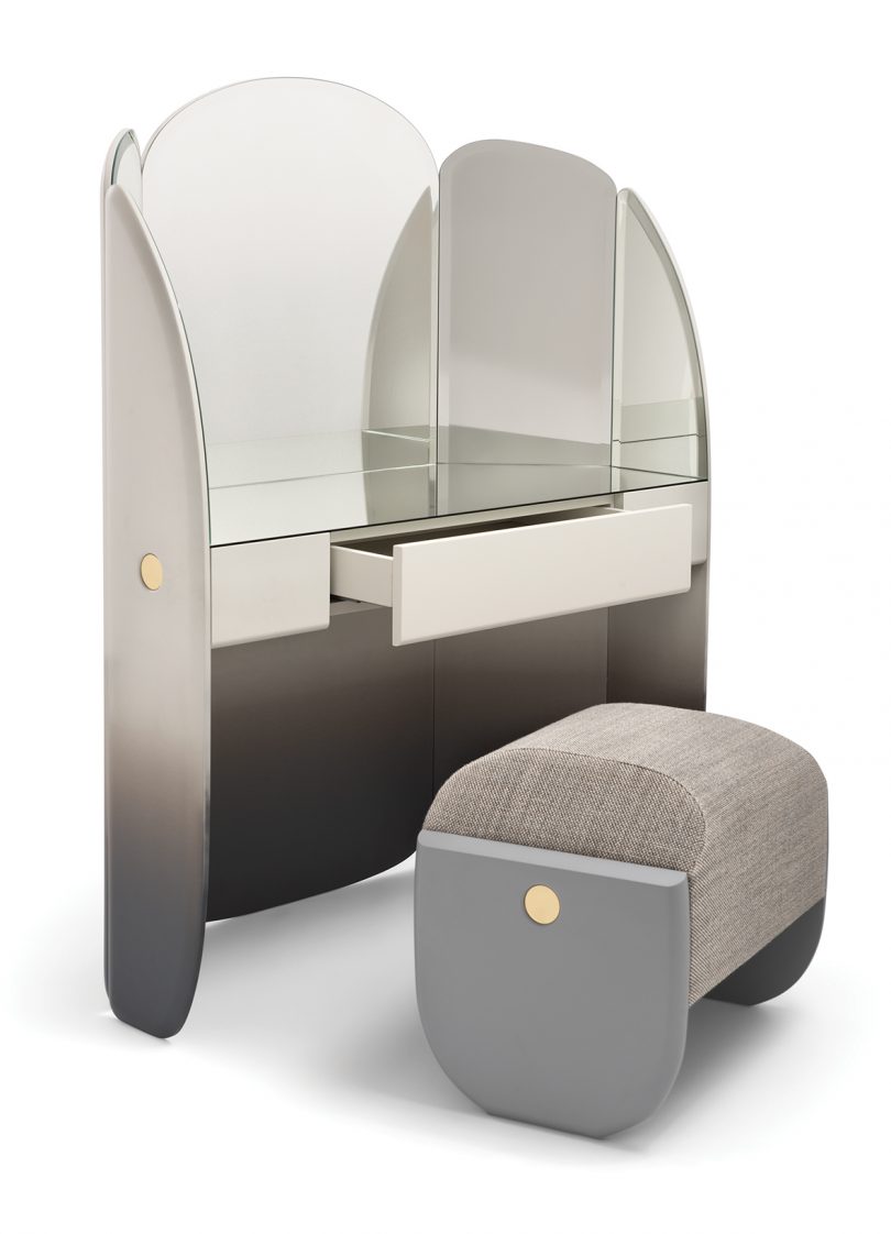 detail of vanity with trifold mirror, drawer, and bench on white background