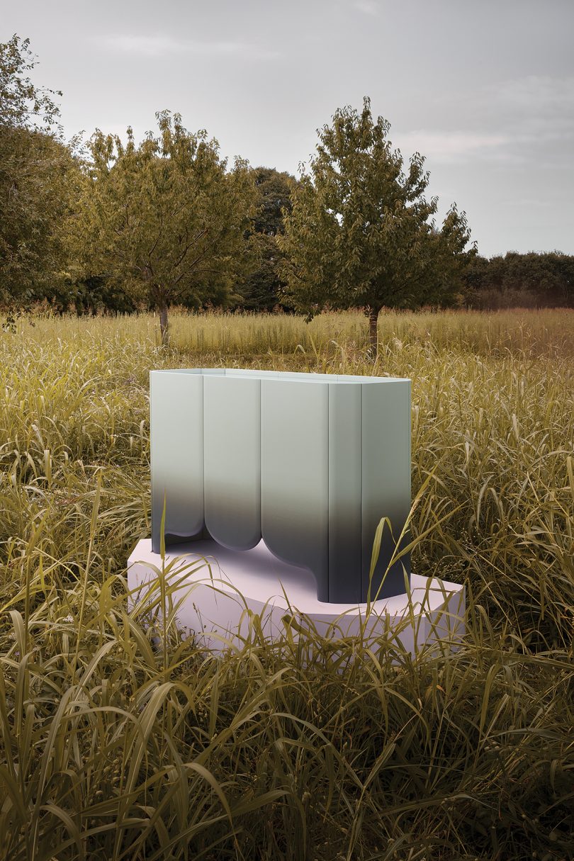 black and grey gradient sideboard on a pedestal in a field