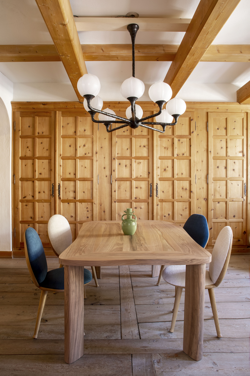 dining space with light wood walls and dining table