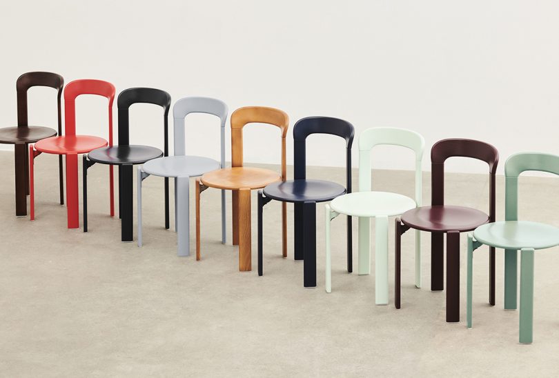 a rainbow of enamel chairs lined up next to each other in a row