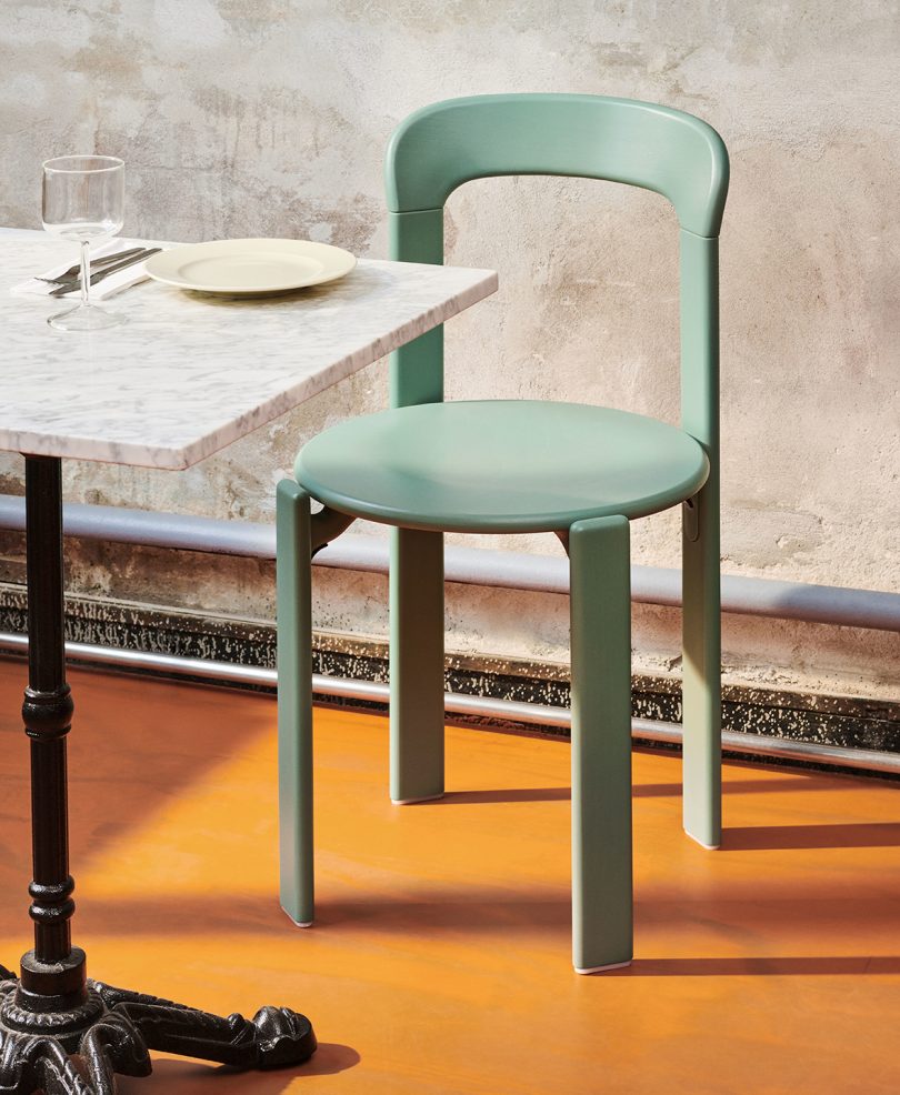 seafoam colored enamel chair at a cafe table