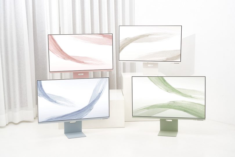 An arrangement of all four Samsung M8 monitors against a white curtain and floor backdrop, shown in (left to right, top to bottom) Sunset Pink, Warm White, Daylight Blue, and Spring Green.