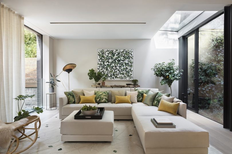 interior living space with large cream colored sectional sofa and black and white artwork