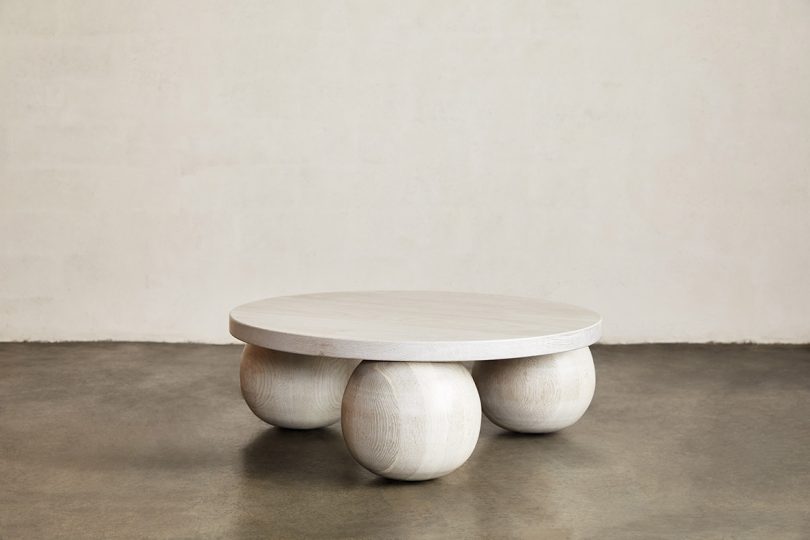 round coffee table in white space with concrete floor