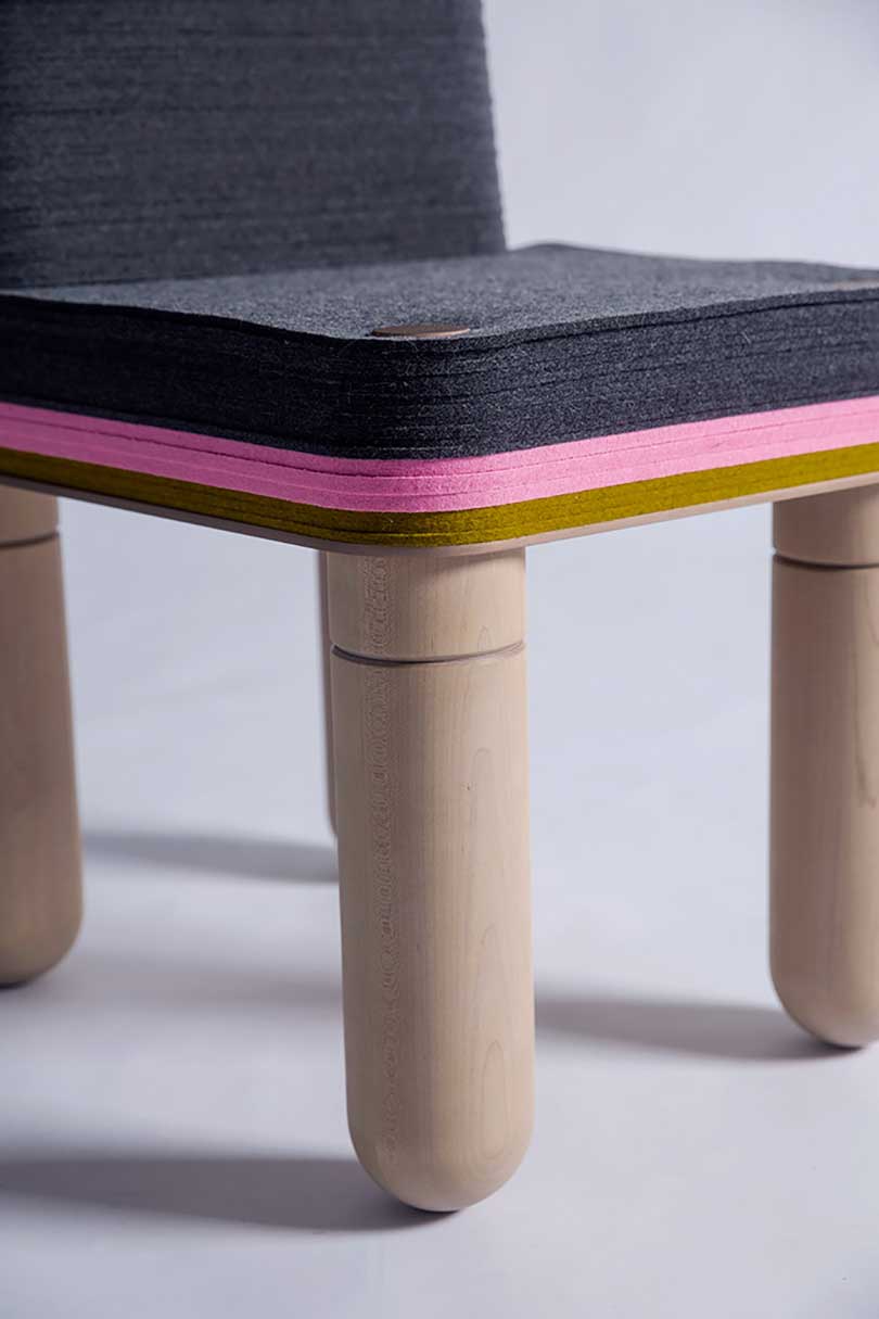 detail of black, pink, and tan felt dining chair