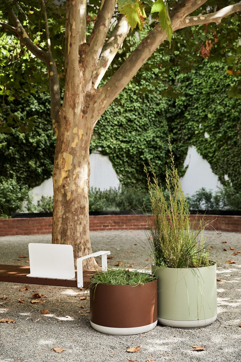 brown and grey outdoor benches and large planter hybrid