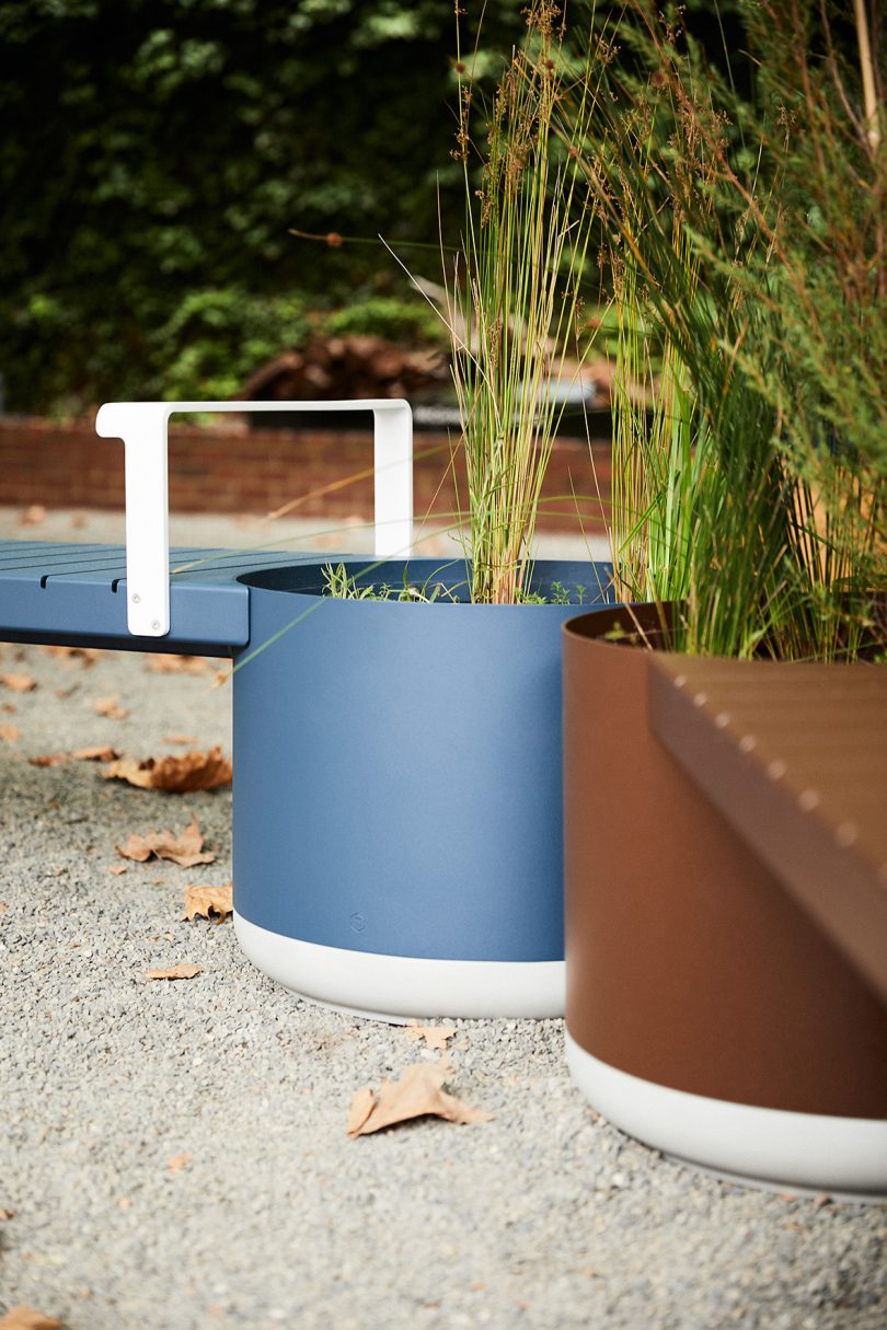 detail of brown and blue outdoor benches and large planter hybrid