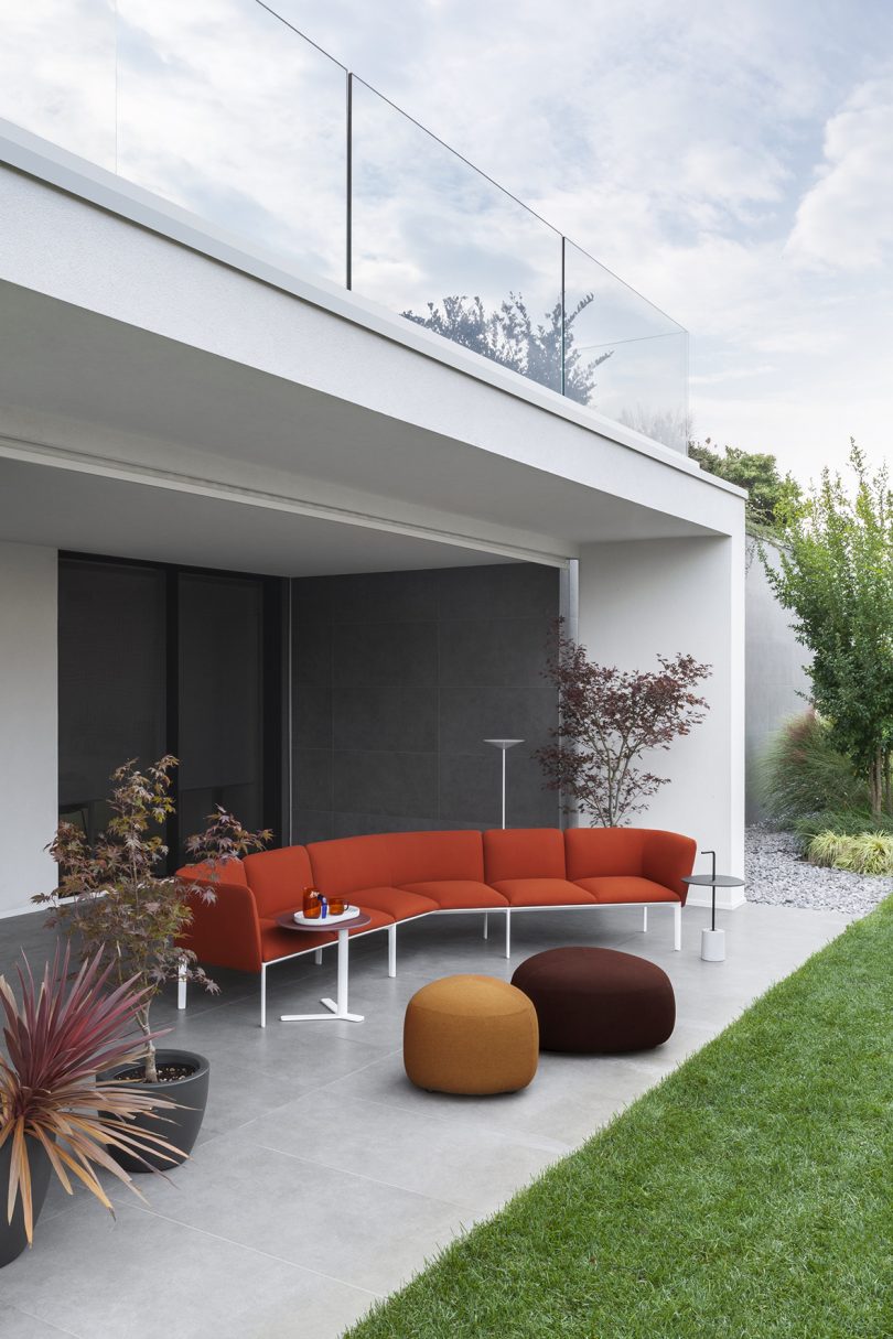 orange outdoor sofa with ottomans on patio