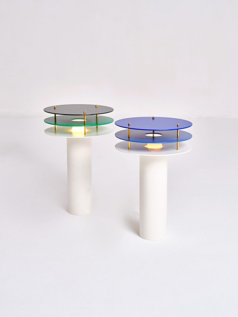 two white lamps with colored acrylic shades