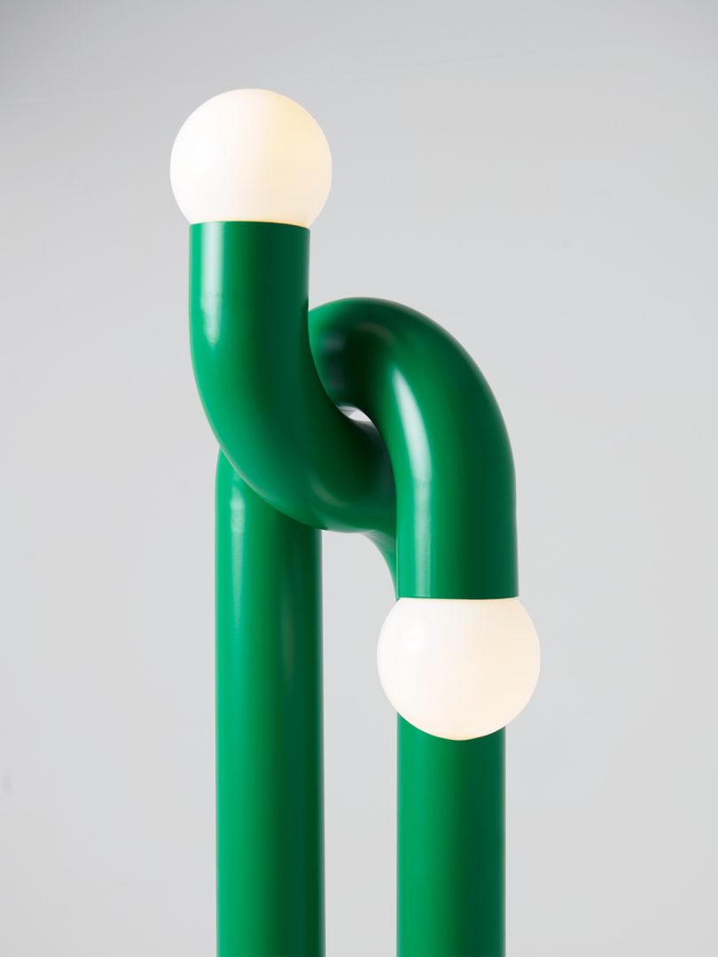 curvaceous green 2-light lamp with round bulbs