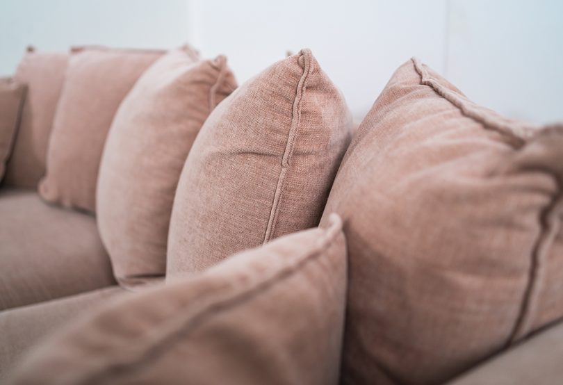 soft pink sofa and pillows
