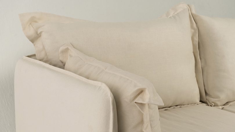 detail of cream colored linen sofa