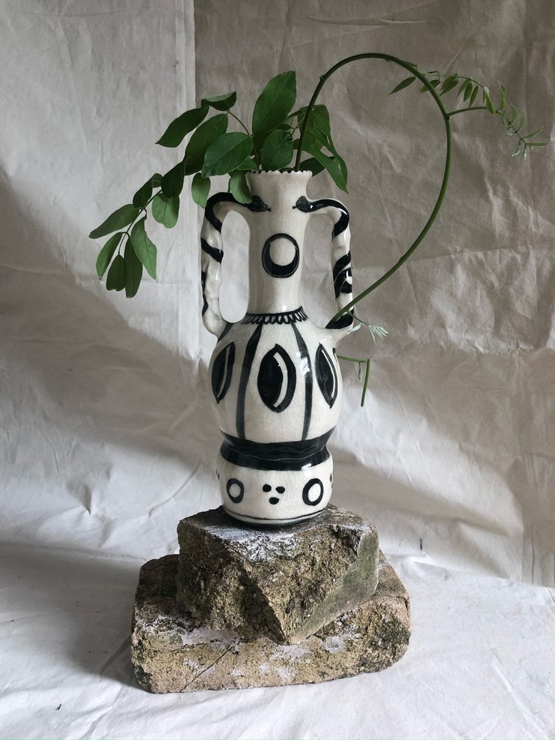 black and white vase with greenery