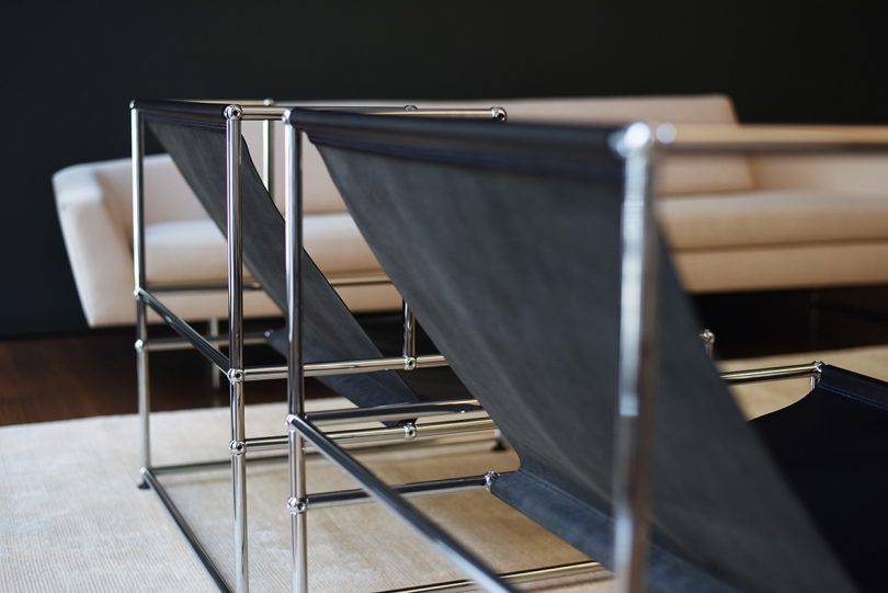 detail of black sling armchairs with metal structure