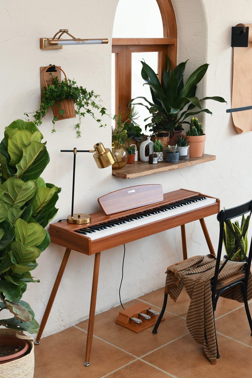 mid-century modern digital piano in styled living space