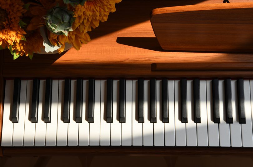 close up image of digital piano keyboard with shadows