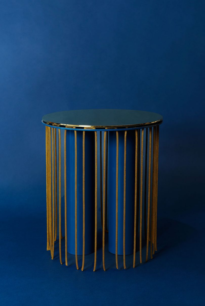 side table with hanging details on dark blue background
