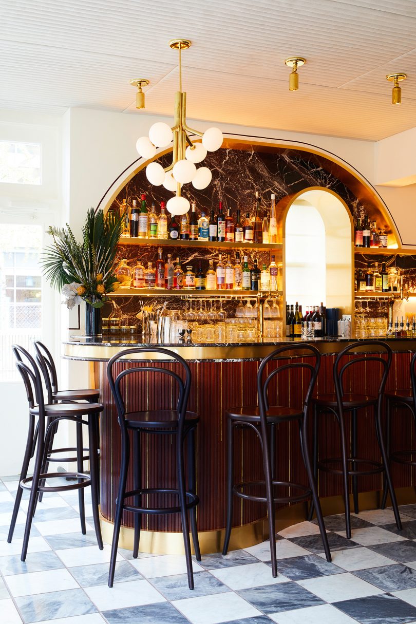 classic bar with stools and modern light fixture
