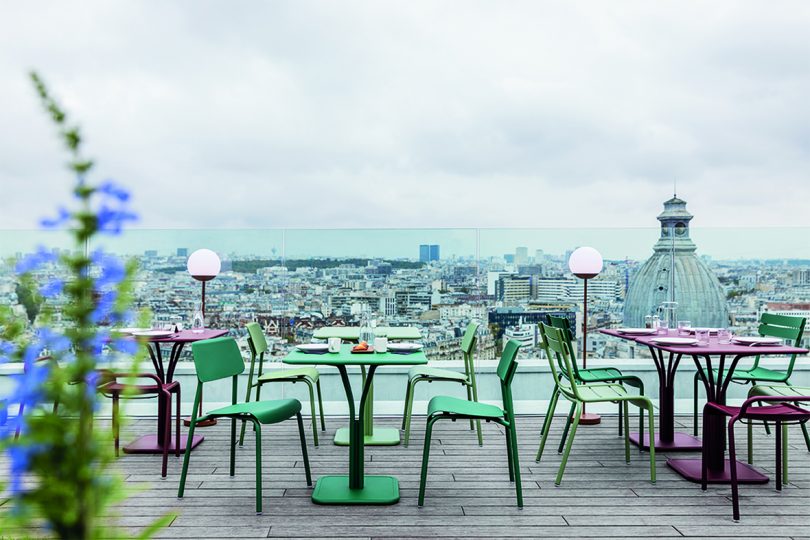 rooftop deck with dining tables and chairs