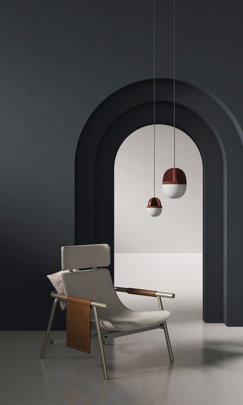 pendant lighting hanging in a styled interior space with archway and armchair