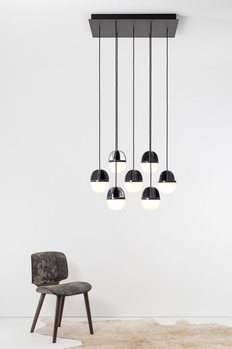 black pendant lights hanging from the ceiling in a white space