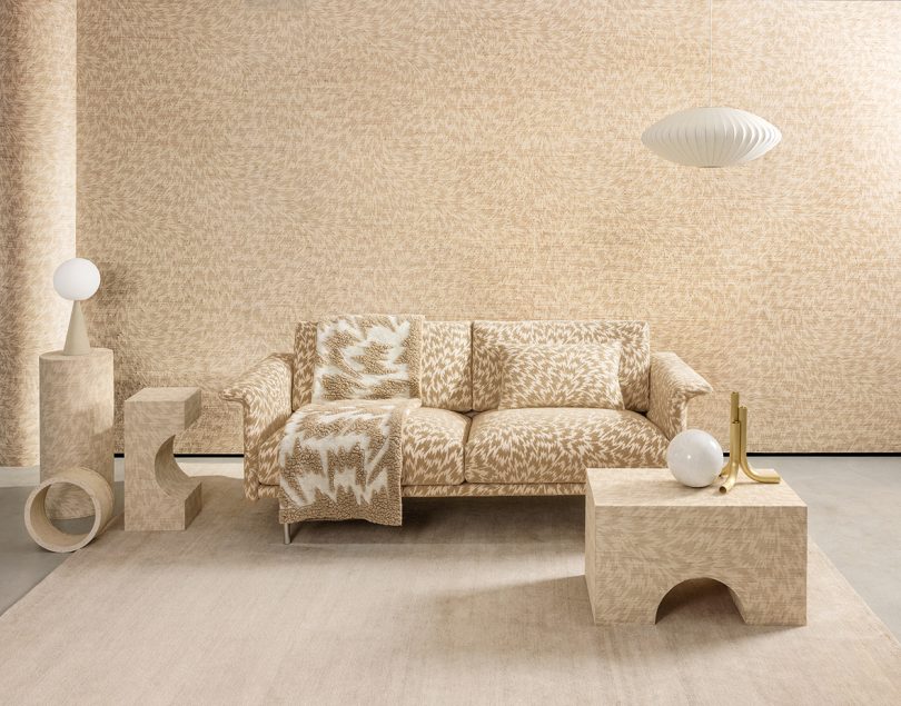 neutral toned sofa, side tables, and wallpaper