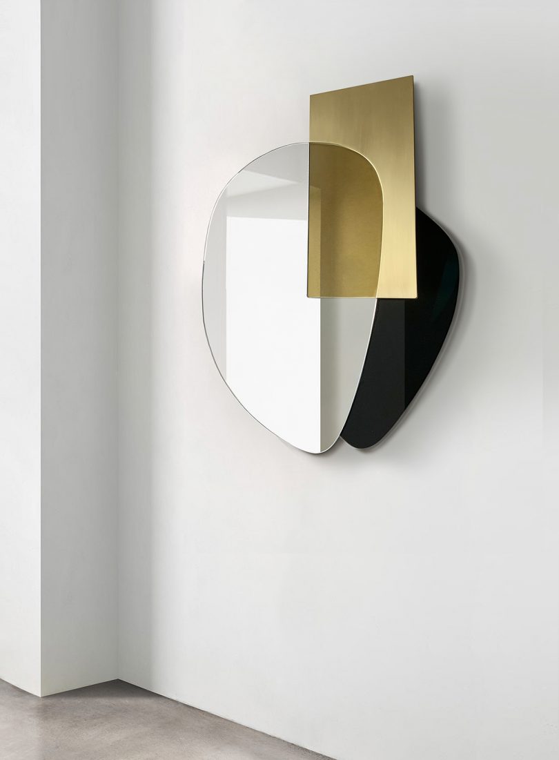 black, gold, and silver wall mirror